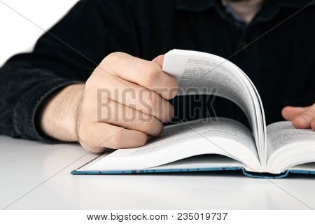 Hands Of A Man Thumbing A Book Closeup