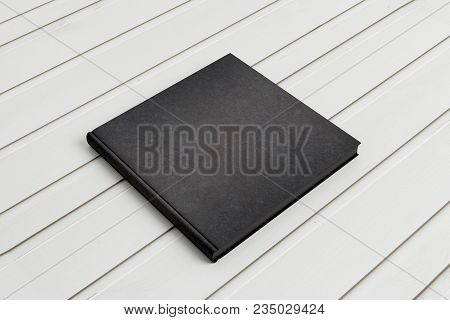 Close Up Of Empty Black Book On Desk. Publish Concept. Mock Up, 3d Rendering