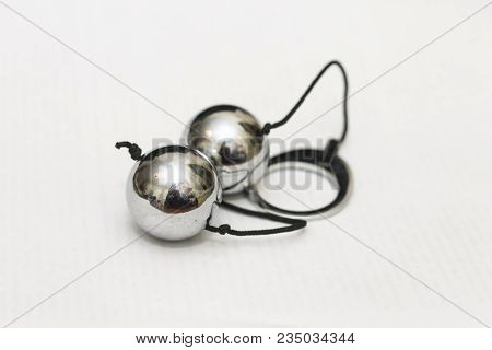 A Two Vaginal Lover Balls In Chrome Isolated On The White Background