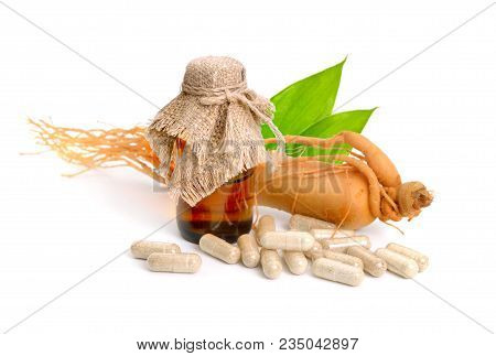 Ginseng Root With Pharmaceutical Bottle And Leawes. Isolated.