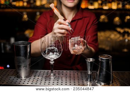 Professional Bartender Breakin A Piece Of Ice For A Fresh Delicious Cocktail At The Steel Bar Counte