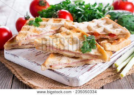 Pressed And Toasted Double Panini With Ham And Cheese Served On A Wooden Table