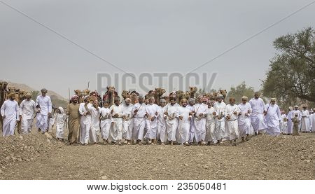 Ibri, Oman, April 7th, 2018: Omani Men Walking And Dancing Following A Traditional Camel Race