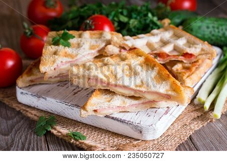 Pressed And Toasted Double Panini With Ham And Cheese Served On A Wooden Table