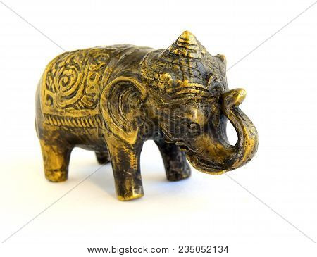 The Sculpture Of An Elephant Is Made Of Old Bronze. The Sculpture Is Located On A White Background