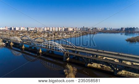 Aerial View Of The City, Ukraine. Dnieper River With Bridges. Darnitskiy Bridge. Combined Railway An