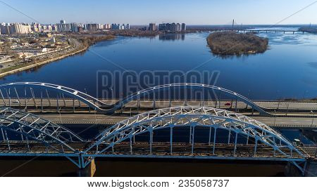 Aerial View Of The City, Ukraine. Dnieper River With Bridges. Darnitskiy Bridge. Combined Railway An