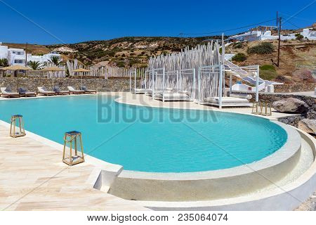 Milos, Greece - May 19, 2017: Blue Luxury Swimming Pool Overlooking The Aegean Sea. Milos, Paleochor