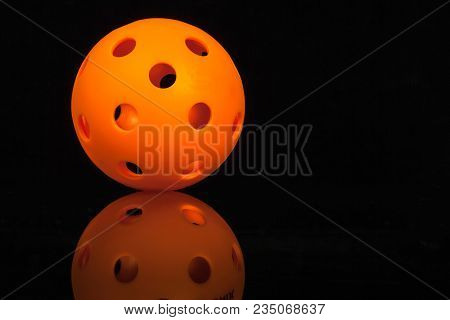 Isolated Mirrored Orange Pickleball On Black Background.
Orange, Pickleball, On, A, Black, Backgroun