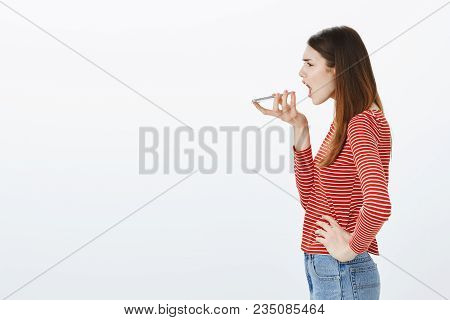 Girl Shouting At Personal Assistant In Smartphone. Attractive European Female Journalist, Standing I