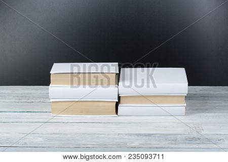 Open Black And Whitel Books On Wooden Table, Black Board Background. Back To School. Education Busin