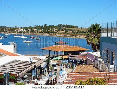 Alvor, Portugal - June 7, 2017 - Restaurant Lined Street With Views Towards The Fish Market And Estu