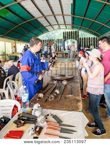Goren, Israel, April 06, 2018 : A Participant In The Knightly Festival Tells Visitors About The Weap