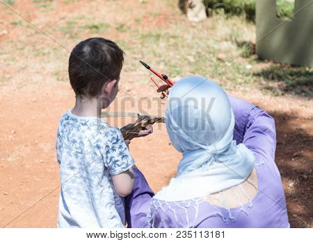 Goren, Israel, April 06, 2018 : A Participant In A Knight Festival Teaches A Visitor How To Shoot A 