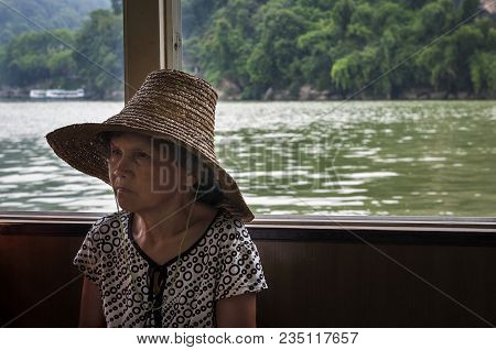 Yangshuo, China - August 2, 2012: Chinese Woman Traveling In A Boat In The Li River Near The Town Of