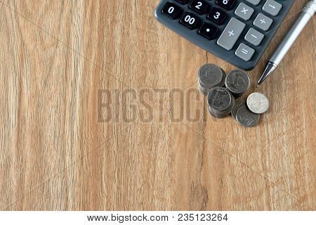 Accounting Concept With Coins Pen Note Book And Calculator On Table.