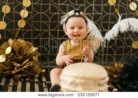Smilin Baby Holding Wooden Happy Birthday Sign. Cake In Front.