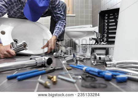 Plumber At Work In A Bathroom, Plumbing Repair Service, Assemble And Install Concept