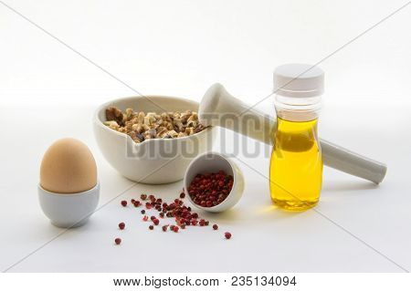 Keto Crackers Recipe Ingredients. Walnuts In Mortar For Grinding, Egg, Vegetable Oil, Spices Cayenne