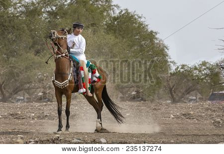 Omani Men On A Horse In  Rural Oman, Racing For Fun