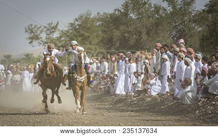 Ibri, Oman, April 7th, 2018: Omani Men Racing Horses In A Countryside Of Oman