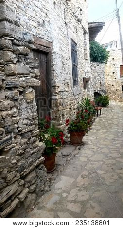 The Narrow Backstreet Decorated With Flowers In Pots And Green Plants, Lefkara, Cyprus.