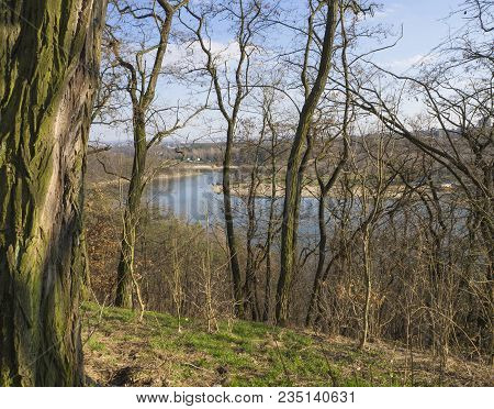 View On Artificial Lake Dam In Prague Park (hostivarska Prehrada) Early Spring Sunny Day, Tree And B