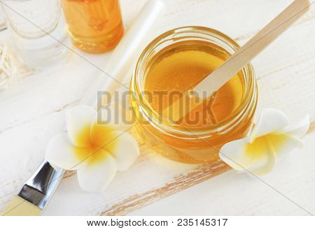 Glass Jar Of Golden Honey Closep With Frangipani Flowers. Preparing Natural Beauty & Body Treatment 