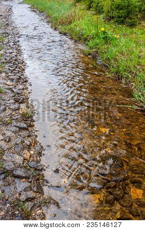 Water Burble Through An Unpaved Road After Rain