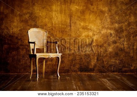 Old Chair On A Brown Wall Background