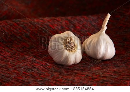 Garlic On A Red Style Background, Selective Focus