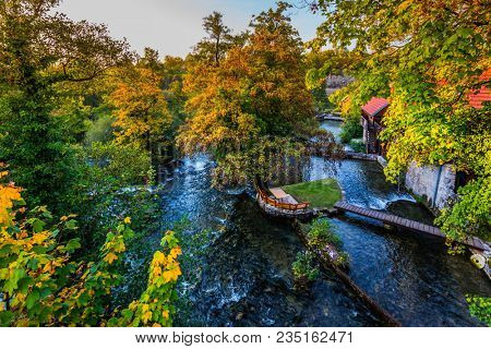 Croatia, Slunj. Amazing park above the water channels of the Korana river. Rural wooden houses are connected by small bridges. Concept of ecological and photo tourism