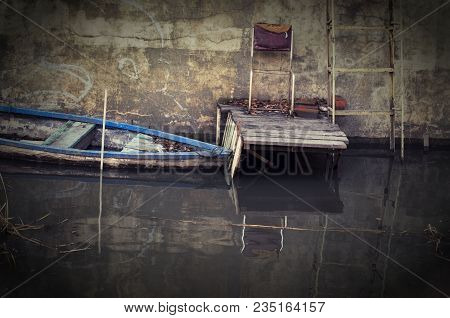 The Boat Is Moored In The Canal By The Pier.