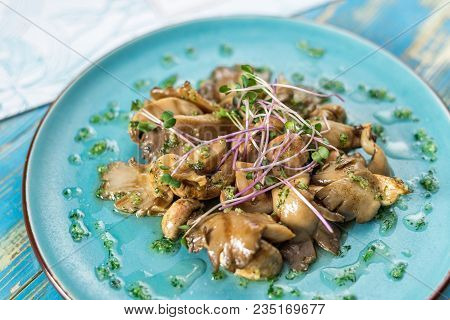 Mushrooms With Herbs On A Blue Plate