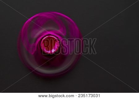 Fidget Finger Metal Spinner, Anxiety Relief Toy On Black Background, Copyspace. Concept Relieving St