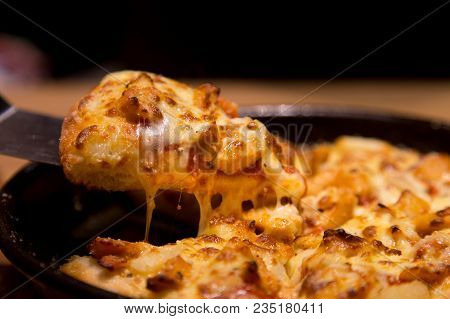 Hot Pizza Slice With Melting Cheese On A  Table In Restaurant Pizza Italian Food.