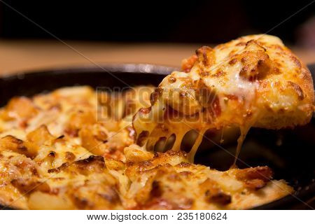 Hot Pizza Slice With Melting Cheese On A  Table In Restaurant Pizza Italian Food.