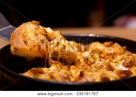 Hot Pizza Slice With Melting Cheese On A  Table In Restaurant Pizza Italian Food.