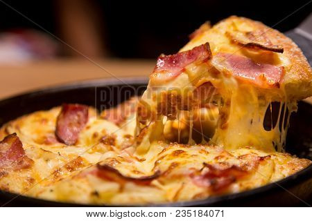 Hot Pizza Slice With Melting Cheese On A  Table In Restaurant Pizza Italian Food.