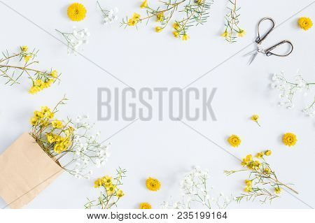 Flowers Composition. Frame Made Of Yellow Flowers On Pastel Blue Background. Florist Workspase. Flat