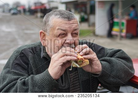 Portrait Of Caucasian Senior Driver Eating Lyulya Kebab In Lavash