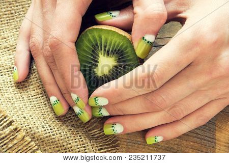 Kiwi And Skin Care Of A Beauty Female Hands With Green And White Moon Nail Art Manicure On A Sackclo