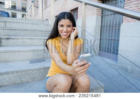 Attractive Latin Woman Listening To Music On Her Smart Phone