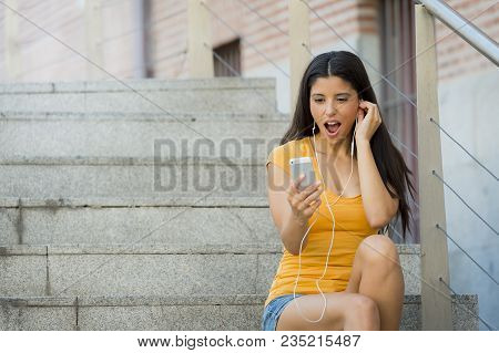 Attractive Latin Woman Shocked Looking At Her Phone