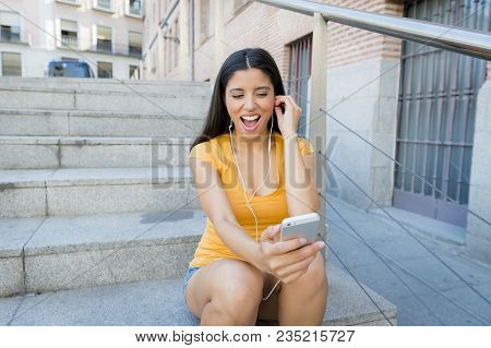 Attractive Latin Woman Listening To Music On Her Smart Phone