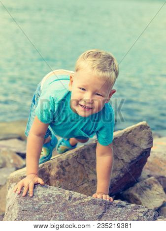 Cute caucasian boy at seaside. Leisure time
