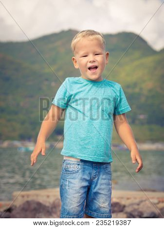 Cute caucasian boy at seaside. Leisure time