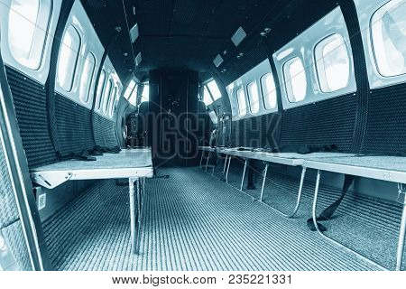 Interior Of Transport Aircraft For Parachute Jump, View To The Cabin With Seats For People. Plane Tr