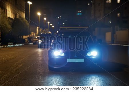 Road In The City At The Night With Yellow And Red Electrical Light For Cars During They Are Coming H