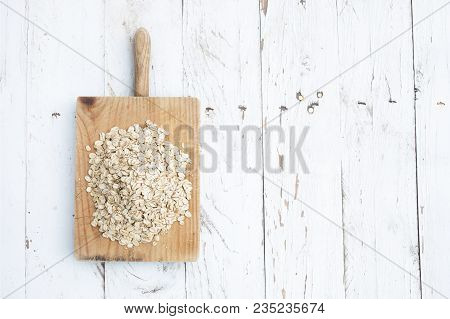 Oatmeal, Rolled Oats On White Wooden Table. Porridge Oats, Used In Granola Or Muesli. Copyspace, Fla